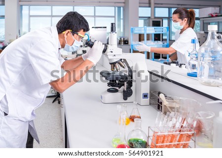 scientists male and female with equipment and science experiments ,laboratory glassware containing chemical liquid for design or decorate science or other your content and selective focus
