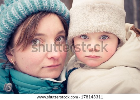 Mom and daughter on a walk at freeze day