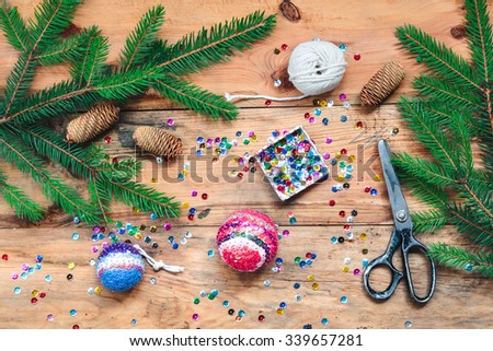 Making Christmas ball pinning the sequins onto the ball