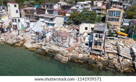 The destroyed house after the earthquake on the seashore.