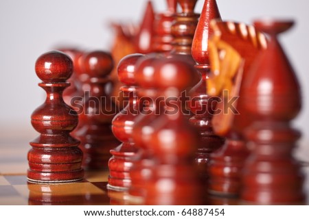 Chess pieces on board (focus on center pawn)