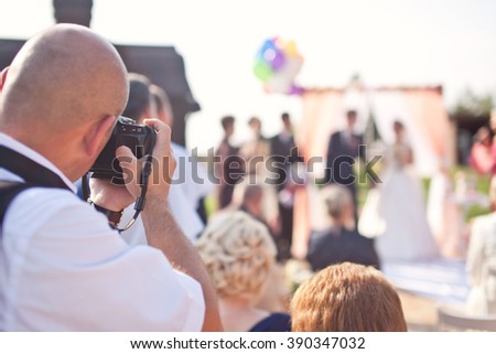 Photographer photographing a wedding ceremony