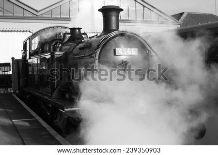 steam train at station shrouded in smoke