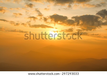 Brilliant orange sunrise over mountain  with bright yellow sun  in the morning