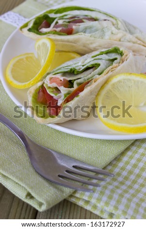smoked fish and vegetables wrapped in a thin flat cake
