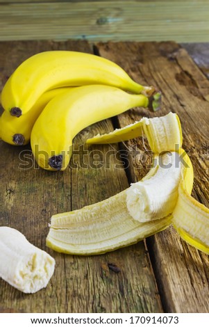 ripe fresh bananas on the table of the old boards