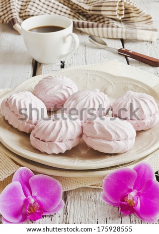 lush pink marshmallows, coffee and orchid on the table
