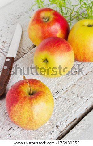 ripe big apples and knife on the table