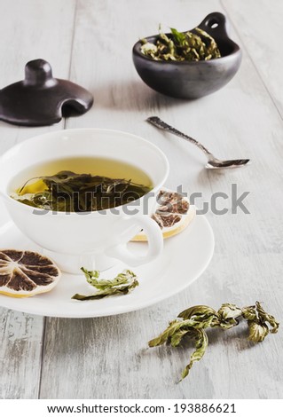 fresh tea from the leaves of mint on a table- health and diet concept