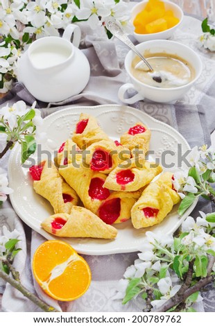 breakfast of fresh rolls, coffee and sliced oranges