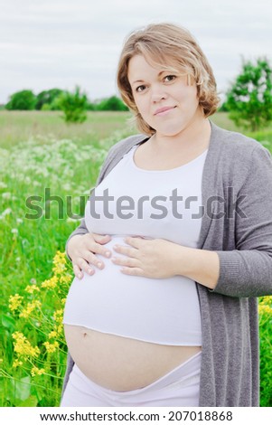 happy pregnant woman holds hands a belly. happy pregnancy.
