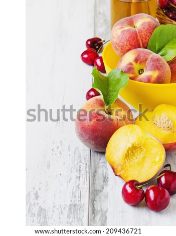 ripe peaches in a bowl, cherry and peach juice on a light background.copy space background. health and diet concept