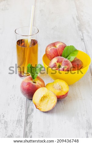ripe peaches in a bowl and peach juice on a light background. selective focus. health and diet food