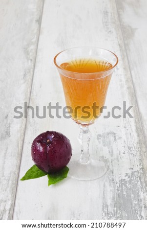 glass of plum juice and ripe plum on a light background.copy space background.selective focus.health and diet food