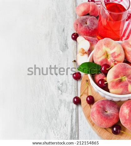 peaches, cherries and cherry juice in a glass on a cutting board.health and diet concept. copy space background