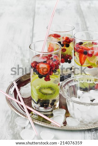 summer cool drink with fresh berries and fruit on the old wooden background. health and diet food