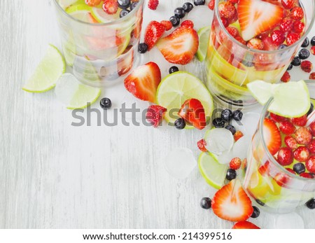 cool drink with fresh berries and fruit on the old wooden background. health and diet food.copy space background