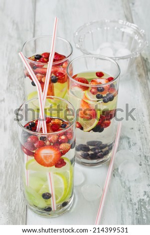 cool drink with fresh berries and fruit on the old wooden background. health and diet food