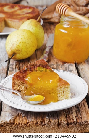 piece of cake with pear jam and fresh pears on old wooden background. pear pie.
