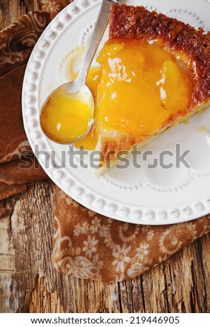 piece of cake with pear jam close up on old wooden background.pear pie