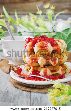freshly baked waffles with strawberry jam and linden tea. sweet breakfast