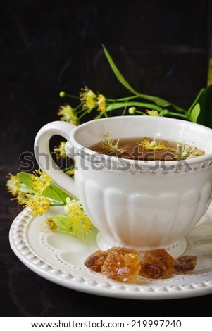 fresh, tasty and healthy linden tea and lumps of sugar on a dark background.health and diet food