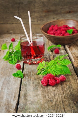 drink of fresh raspberries and ripe raspberry on the old wooden table. health and diet food