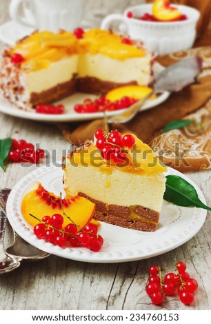 a piece of peach cake with red currant berries in a plate on the holiday table.celebratory food. selective focus