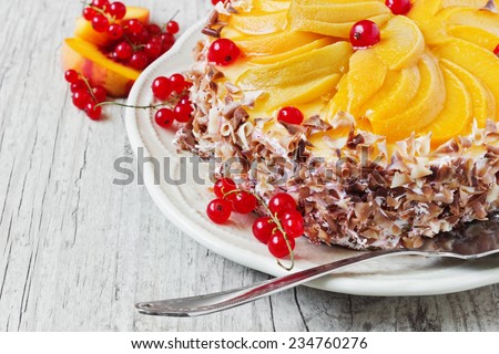 delicious cake with apricot slices and red currant on wooden background close-up. festivals and events.selective focus