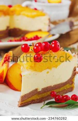 piece of peach cake with red currant berries in a plate on the festive table close up. celebratory food. selective focus