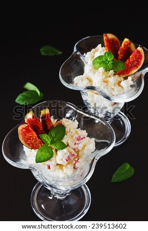 curd dessert with sliced fruit and fresh mint leaves on a black background. health and diet food. selective focus