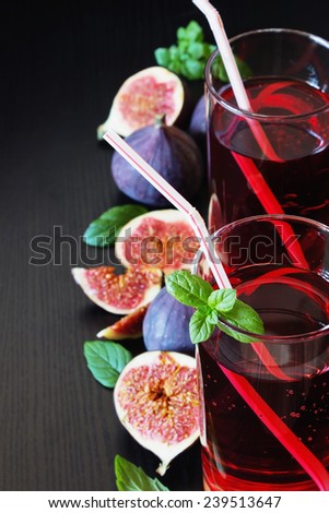 fruit drink and ripe figs on a black background.health and diet food. selective focus