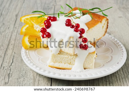 cottage cheese casserole, fresh fruit and berries on a plate on a wooden background. health or diet concept