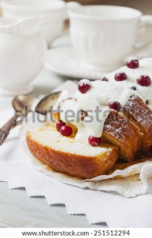 large sliced cupcake with white frosting and fresh cranberries on the holiday table. holiday meal. selective focus