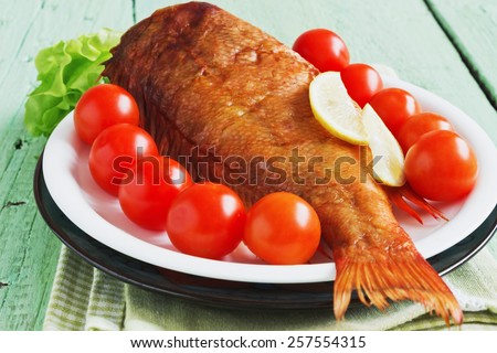 lunch of smoked sea bass on wooden background. food of the useful seafood. health and diet food