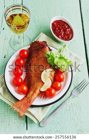 lunch of smoked sea bass on green wooden background. food of the useful seafood. health and diet food.