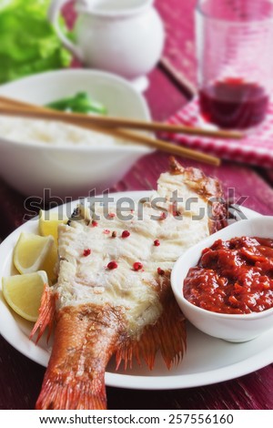 lunch of smoked sea bass and vegetables on  wooden background.  food of the useful seafood. health and diet food. selective focus