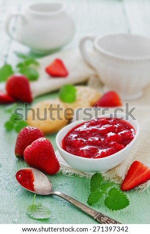 strawberry jam and fresh ripe strawberries on the table. grandma\'s jam. selective focus