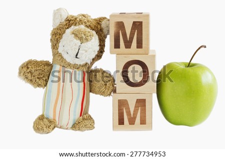 children\'s toys, bear and wooden blocks with letters. creative idea for raising and caring for a child. white background
