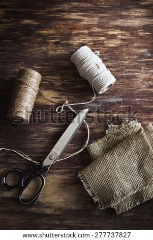 old tailoring scissors and supplies for sewing on an old wooden background. top view