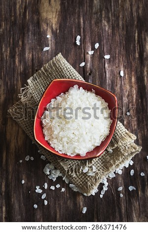 rice flakes in a bowl on the old wooden background.top view.health and diet food
