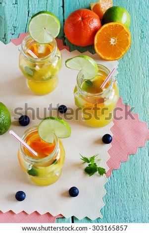 orange soft drink with fruit on a green wooden background.health and diet food.top view