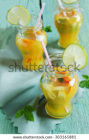 orange soft drink with fruit on a green wooden background.health and diet food. selective focus