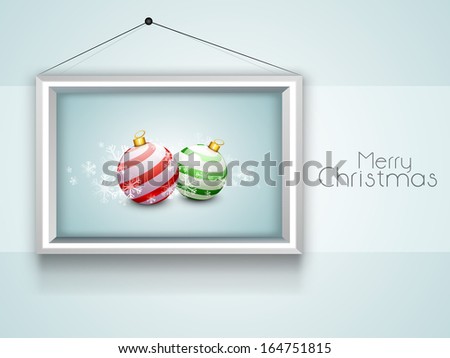 Creative Merry Christmas celebration greeting card or invitation card with decorated Christmas balls in frame on grey background.