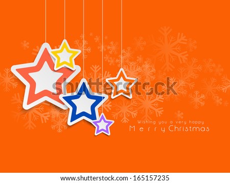 Merry Christmas celebration greeting card or invitation card with hanging stars on snowflakes decorated orange background,