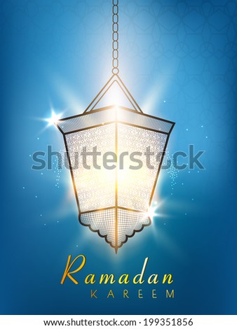Hanging illuminated lantern on shiny blue background for holy month of Muslim community Ramadan Kareem.