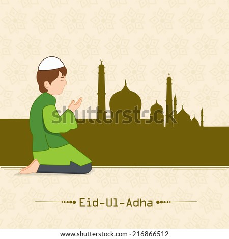 Muslim boy praying (Namaz, Islamic Prayer) in front of mosque on beige background for Eid-Ul-Adha festival celebrations.