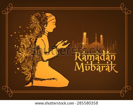 Young religious boy praying Namaz (Islamic Prayer) in front of a shiny mosque on floral brown background for holy month of Muslim community, Ramadan Mubarak celebration.