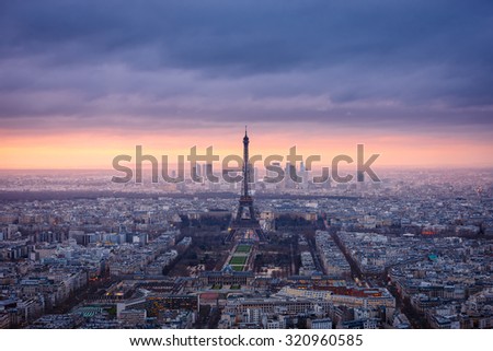 Paris cityscape clad in pink at dusk. Aerial view of Paris and its famous monuments and sites such as Eiffel Tower, Champ de Mars, Grand Palais, Trocadero, Palais de Chaillot, and La Defense.