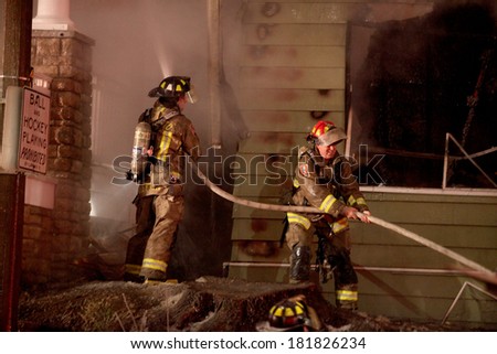 TORONTO - CIRCA JANUARY 2010 - Firefighters battle a four alarm fire involving three homes in the Beach neighborhood of the city.